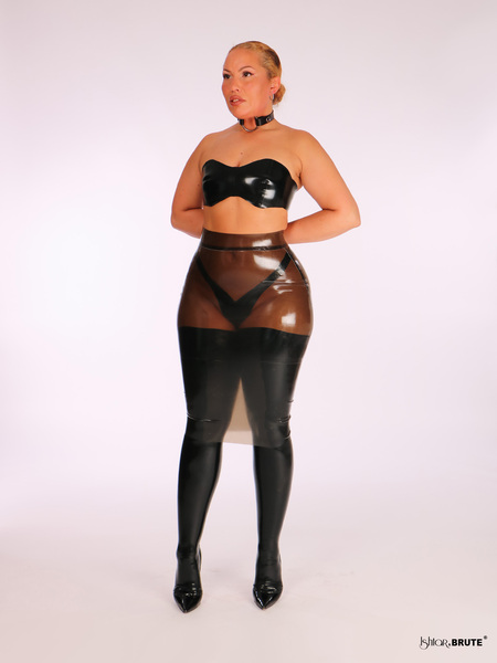 Model wearing a black latex bandeau top with a sweetheart neckline, styled with a latex pencil skirt for night-time kink fashion.