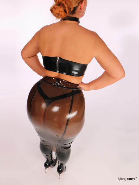 High-waisted semi-transparent latex pencil skirt styled with latex stockings, showcasing a sleek fetish-inspired evening look.