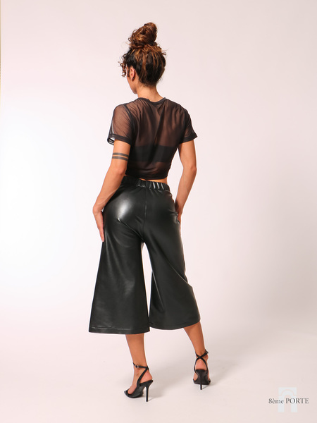 Back view of handmade black faux leather culottes showing the clean, pocket-free back design.