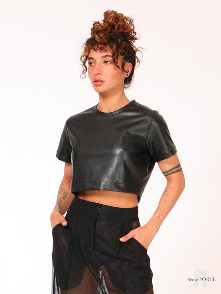 detailed close up of the cropped faux leather tee highlighting the flattering length that sits perfectly above the waistline.