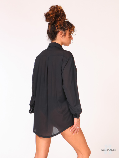 Close-up back view of oversized black sheer shirt showcasing the clean shoulder tailoring and fabric texture.